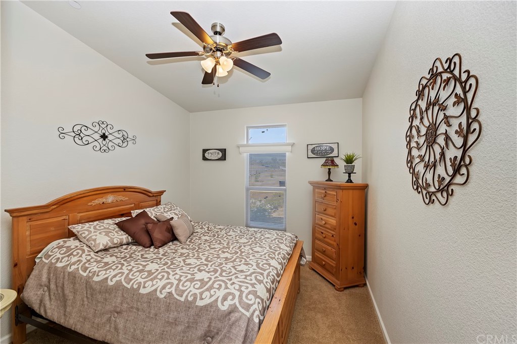 23161 Forrest Road Perris, CA 92570 - Photo 25 of 43 a bedroom with a bed and a chandelier