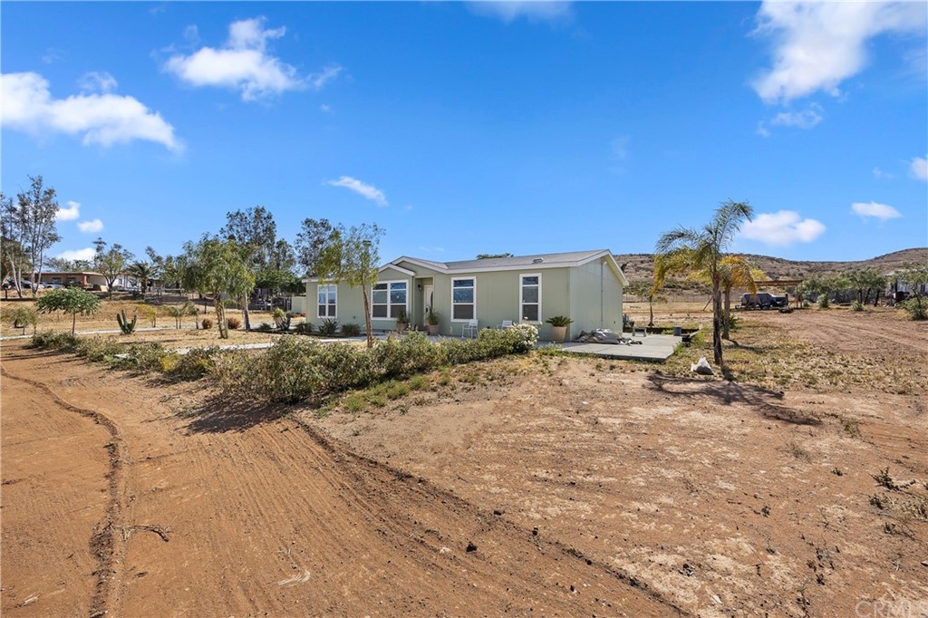 23161 Forrest Road Perris, CA 92570 - Photo 3 of 43 a view of a house with a yard