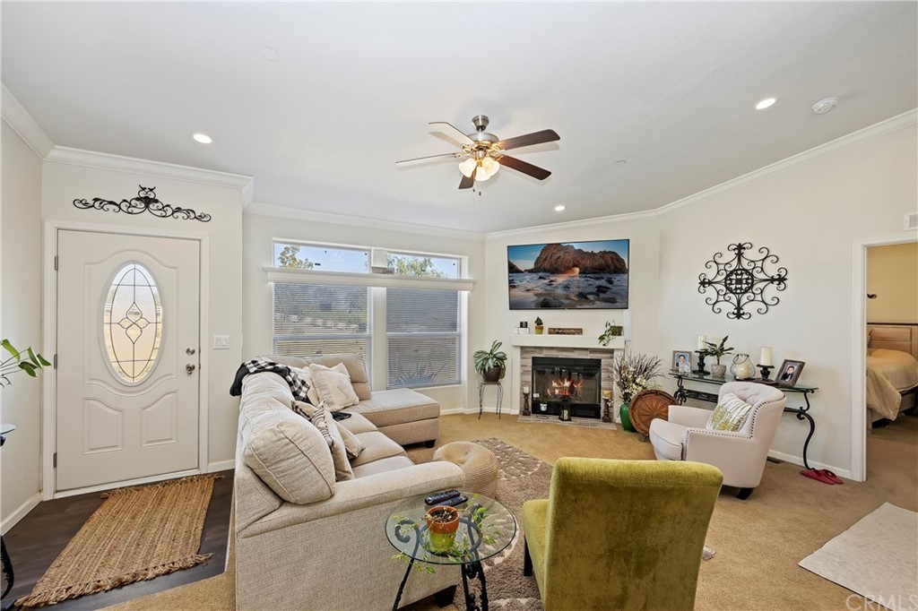 23161 Forrest Road Perris, CA 92570 - Photo 7 of 43 a living room with furniture a fireplace and a flat screen tv