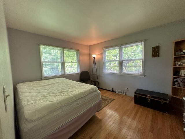224 Maple Lane Geneva, IL 60134 - Photo 8 of 12 a bed sitting in a bedroom next to a window