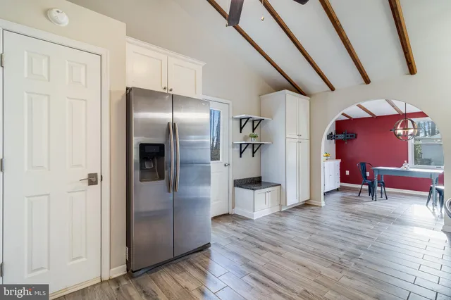 a kitchen with stainless steel appliances granite countertop a refrigerator and a sink