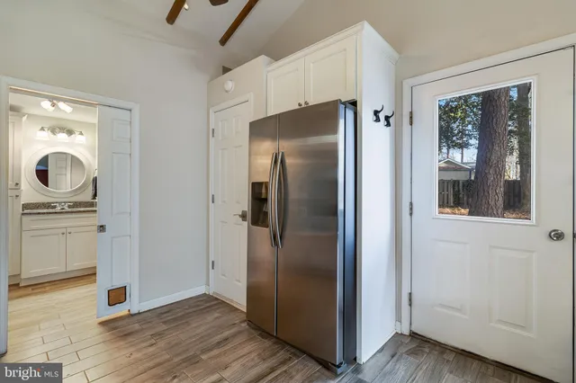 a view of a kitchen with refrigerator and cabinet
