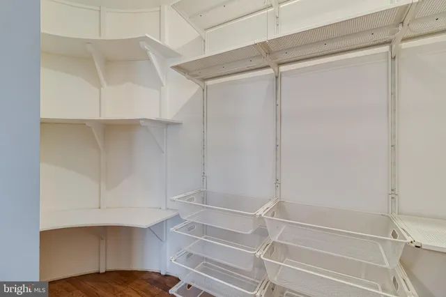 a view of walk in closet with empty racks