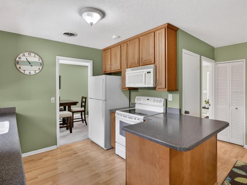 2803 Banchory Road Winter Park, FL 32792 - Photo 8 of 31 a kitchen with granite countertop a table chairs and refrigerator