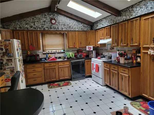 a kitchen with stainless steel appliances a stove a sink dishwasher and cabinets