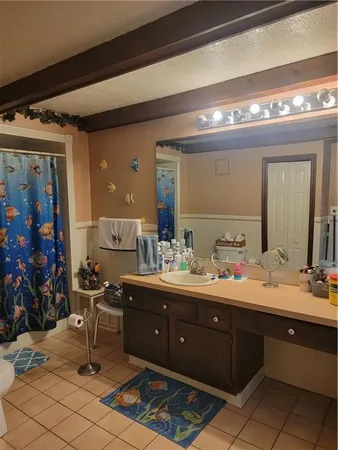 a spacious bathroom with double vanity and a mirror