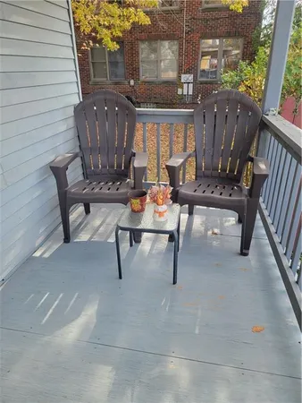 a view of a bench in wooden deck
