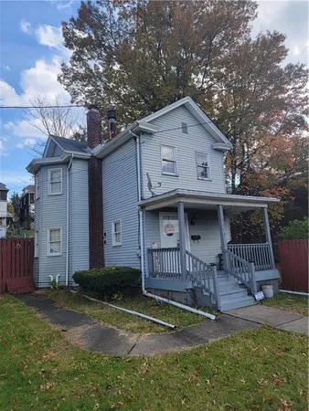 a view of a house with a yard and deck