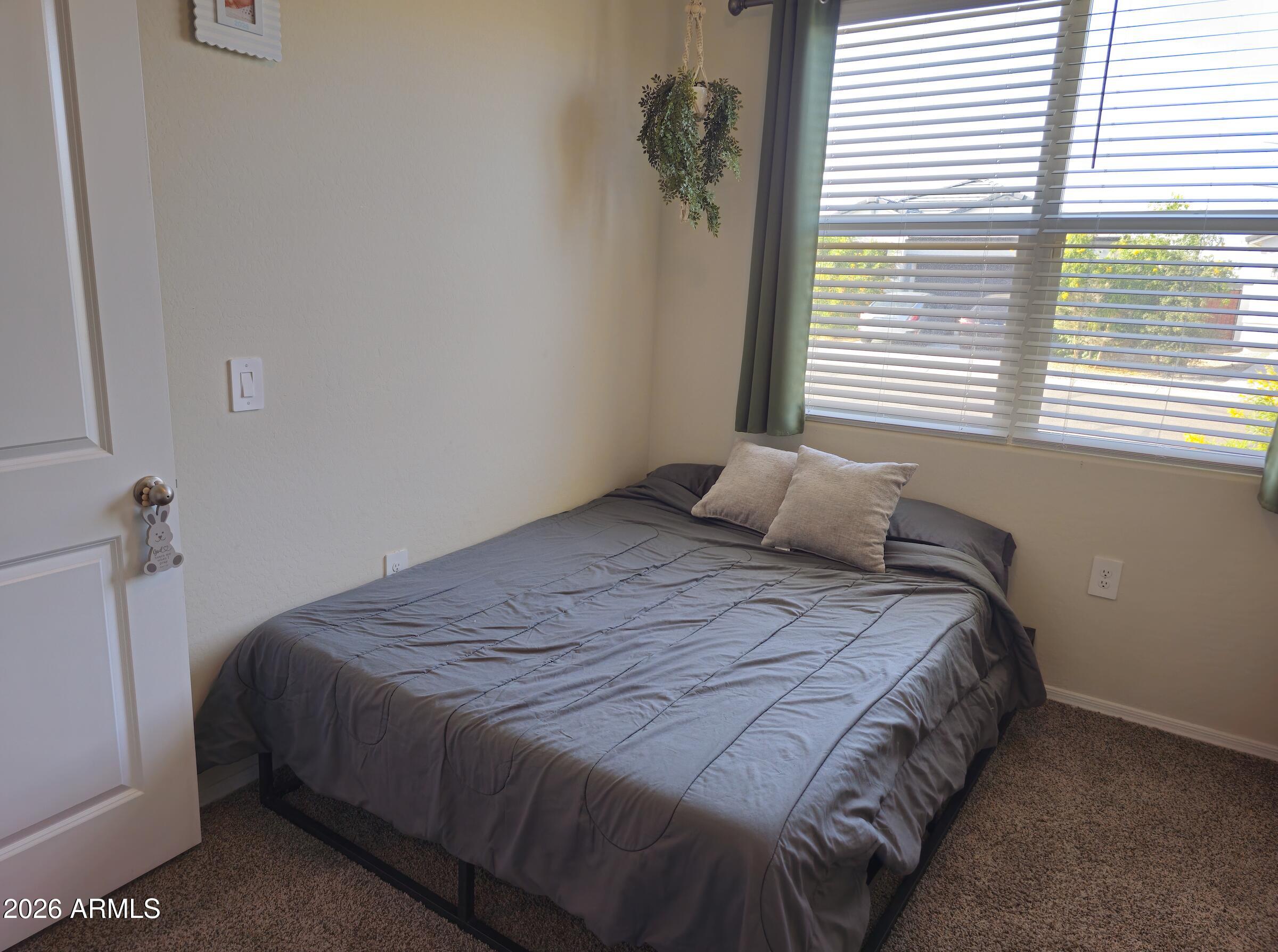 9434 Cotton Road Florence, AZ 85132 - Photo 22 of 25 a bedroom with a bed and a window