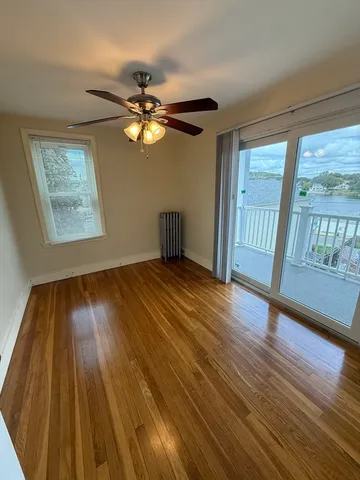 wooden floor in an empty room with a window