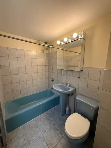 a bathroom with a sink a toilet and bathtub