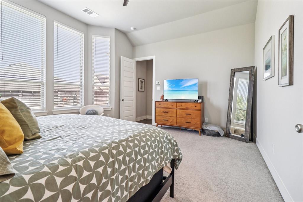 847 Longbranch Way Little Elm, TX 76227 - Photo 25 of 39 Bedroom featuring carpet floors, vaulted ceiling, and a ceiling fan