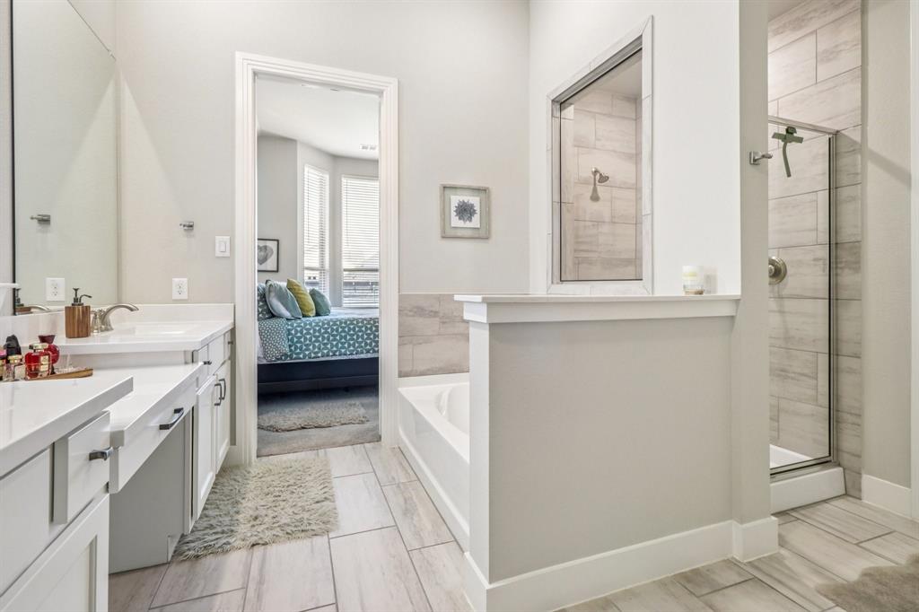 847 Longbranch Way Little Elm, TX 76227 - Photo 27 of 39 Ensuite bathroom with vanity, a stall shower, a bath, and wood tiled floors