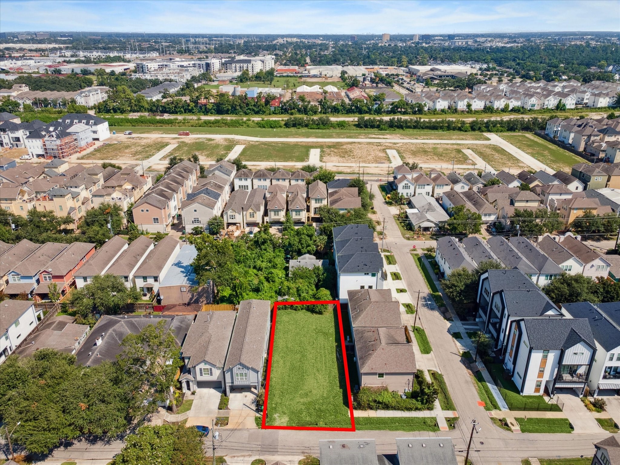 an aerial view of residential houses with outdoor space and river