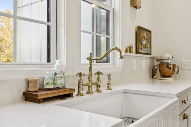 a hallway with a white cabinets and wooden floor