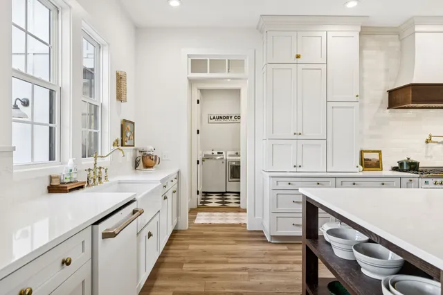 a white bath tub sitting in a bathroom next to a window