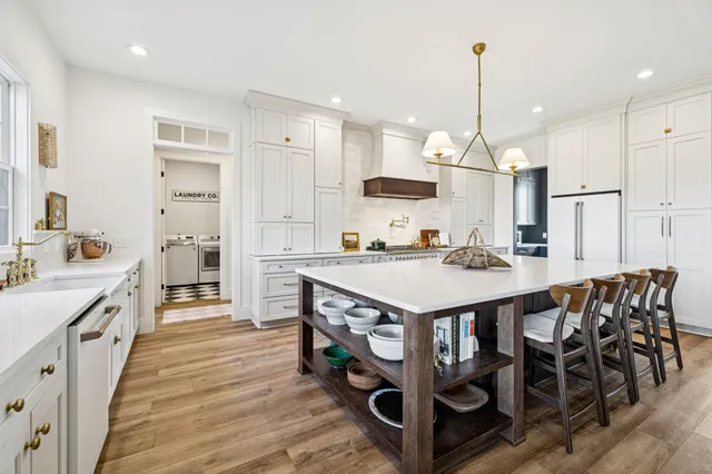 a bathroom with a sink a toilet a mirror and shower