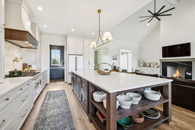 a bathroom with a granite countertop double vanity sink a mirror and a shower