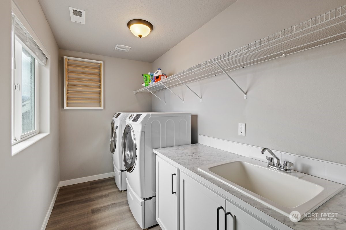 1835 Hood River Road Liberty Lake, WA 99016 - Photo 11 of 37 a utility room with a sink a washer and dryer