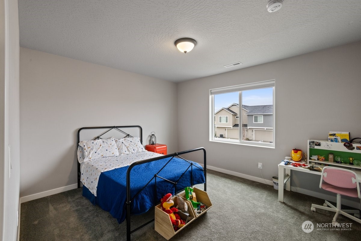 1835 Hood River Road Liberty Lake, WA 99016 - Photo 13 of 37 a bedroom with a bed and a window
