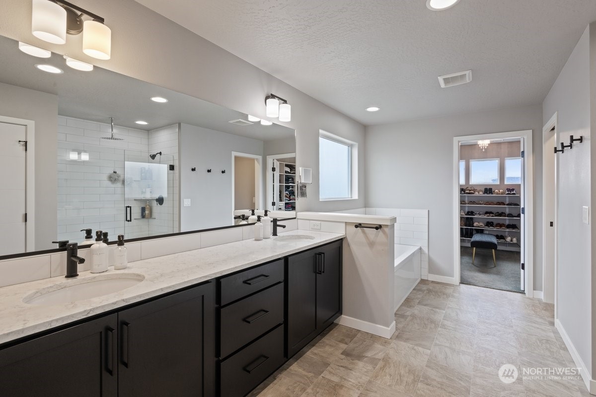 1835 Hood River Road Liberty Lake, WA 99016 - Photo 14 of 37 a large bathroom with a double vanity sink a large mirror and a shower
