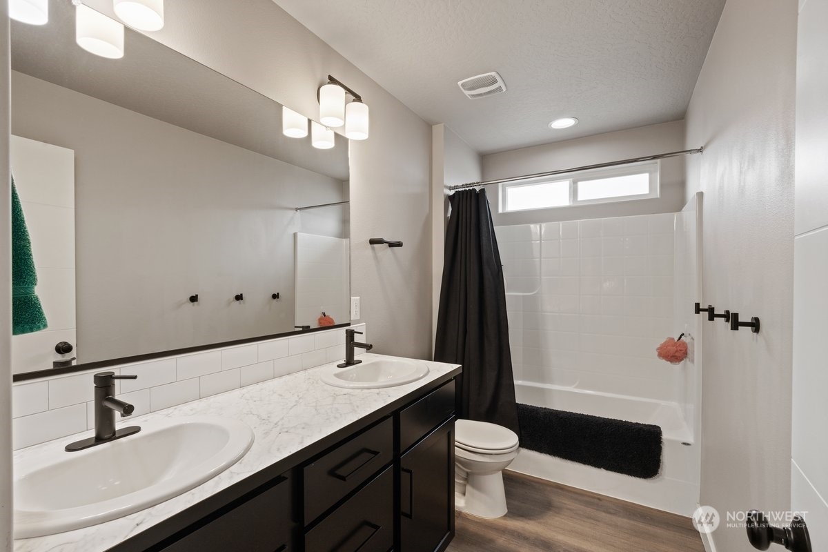 1835 Hood River Road Liberty Lake, WA 99016 - Photo 15 of 37 a bathroom with a sink a toilet a mirror and shower