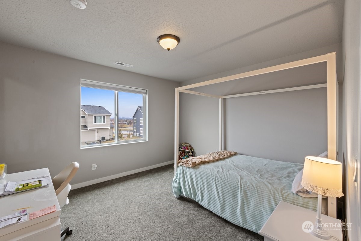 1835 Hood River Road Liberty Lake, WA 99016 - Photo 18 of 37 a bedroom with a bed and a window