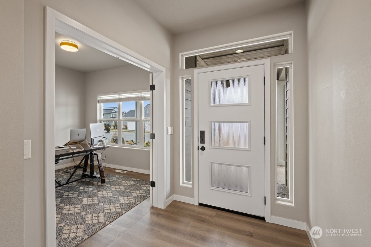 1835 Hood River Road Liberty Lake, WA 99016 - Photo 2 of 37 a view of a hallway with wooden floor and furniture