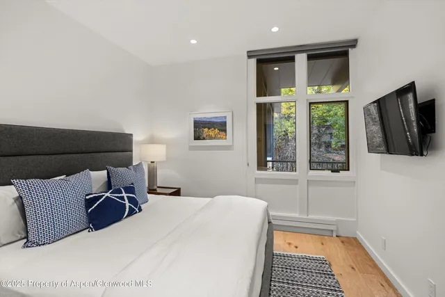 a bedroom with a large bed and a window