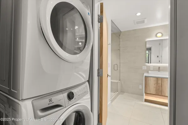 a view of bathroom with washing machine and sink