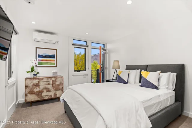 a bedroom with a bed and a couch