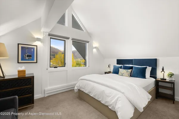 a bedroom with a bed and a desk