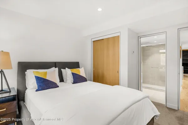 a bedroom with a bed and a night stand