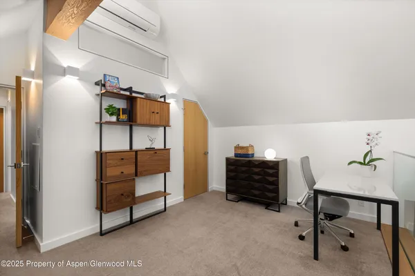 a bedroom with furniture and a window