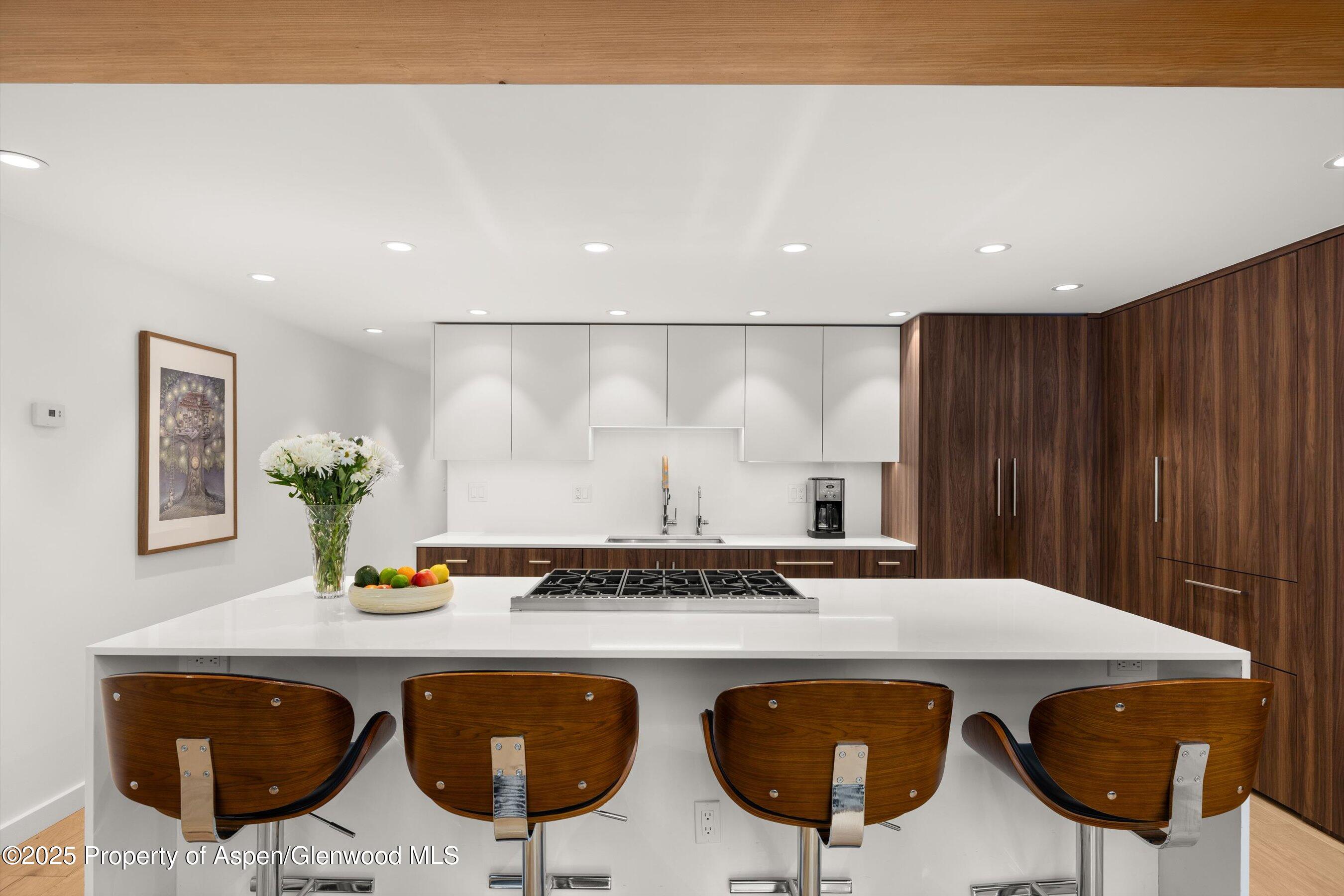 800 South Mill Street, Unit 303C Aspen, CO 81611 - Photo 7 of 32 a kitchen with a table and chairs in it