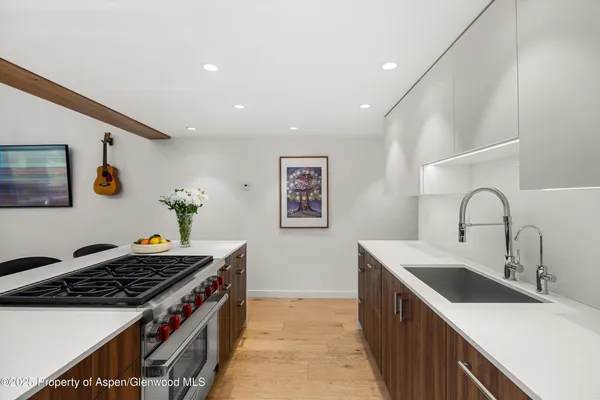 a kitchen that has a sink and a stove