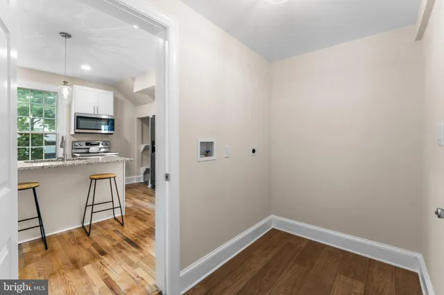 a view of kitchen with cabinets and wooden floor