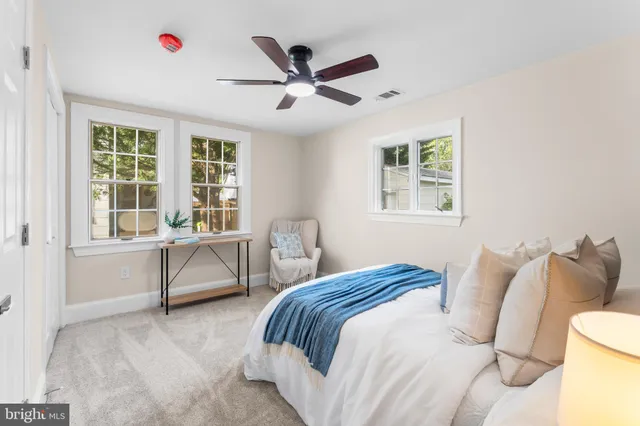 a bedroom with a bed and a large window