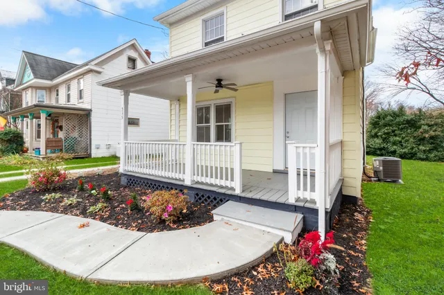a view of a house with a garden and plants