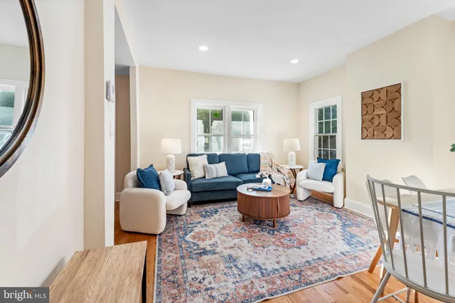 a living room with furniture a rug and a window