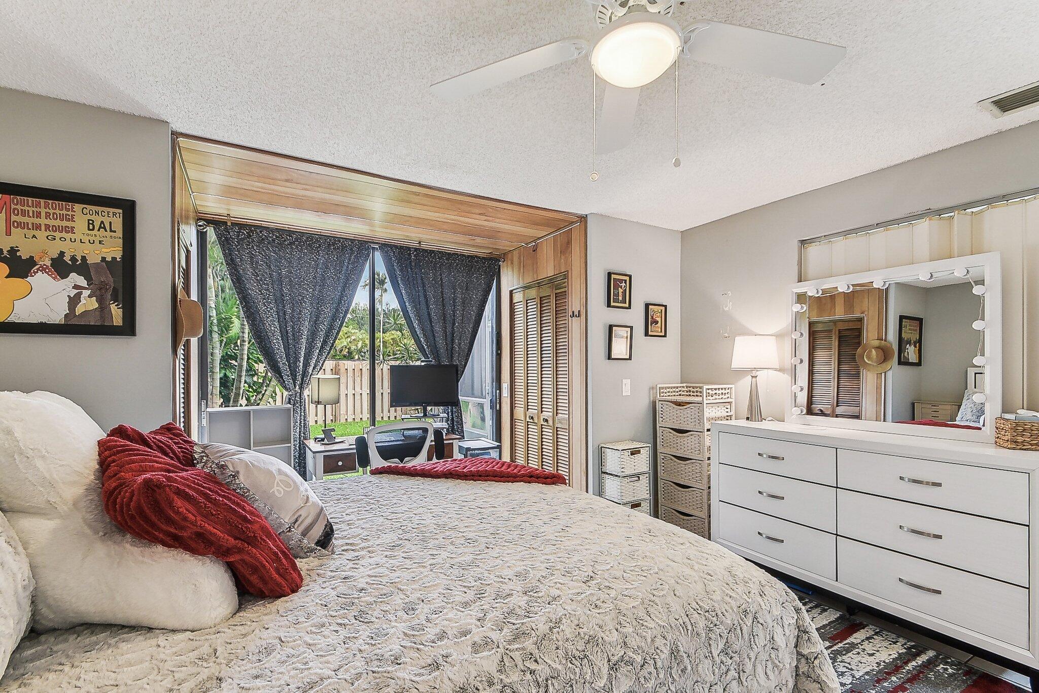 11063 Oakdale Road Boynton Beach, FL 33437 - Photo 15 of 65 a bed room with a bed and a large window