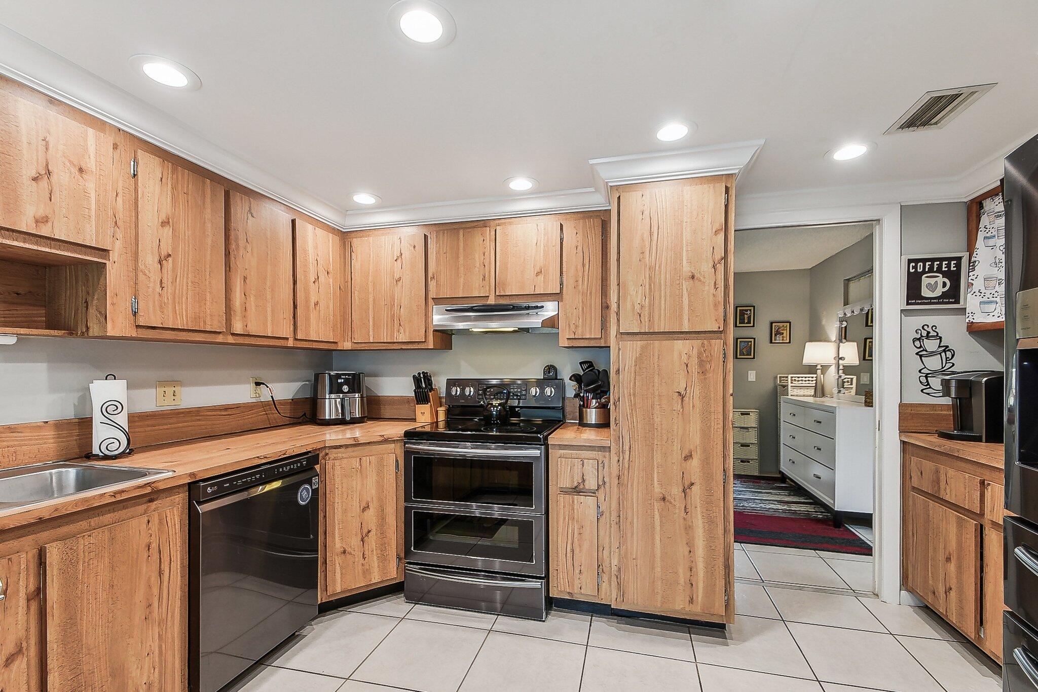 11063 Oakdale Road Boynton Beach, FL 33437 - Photo 18 of 65 a kitchen with stainless steel appliances granite countertop a refrigerator and a sink