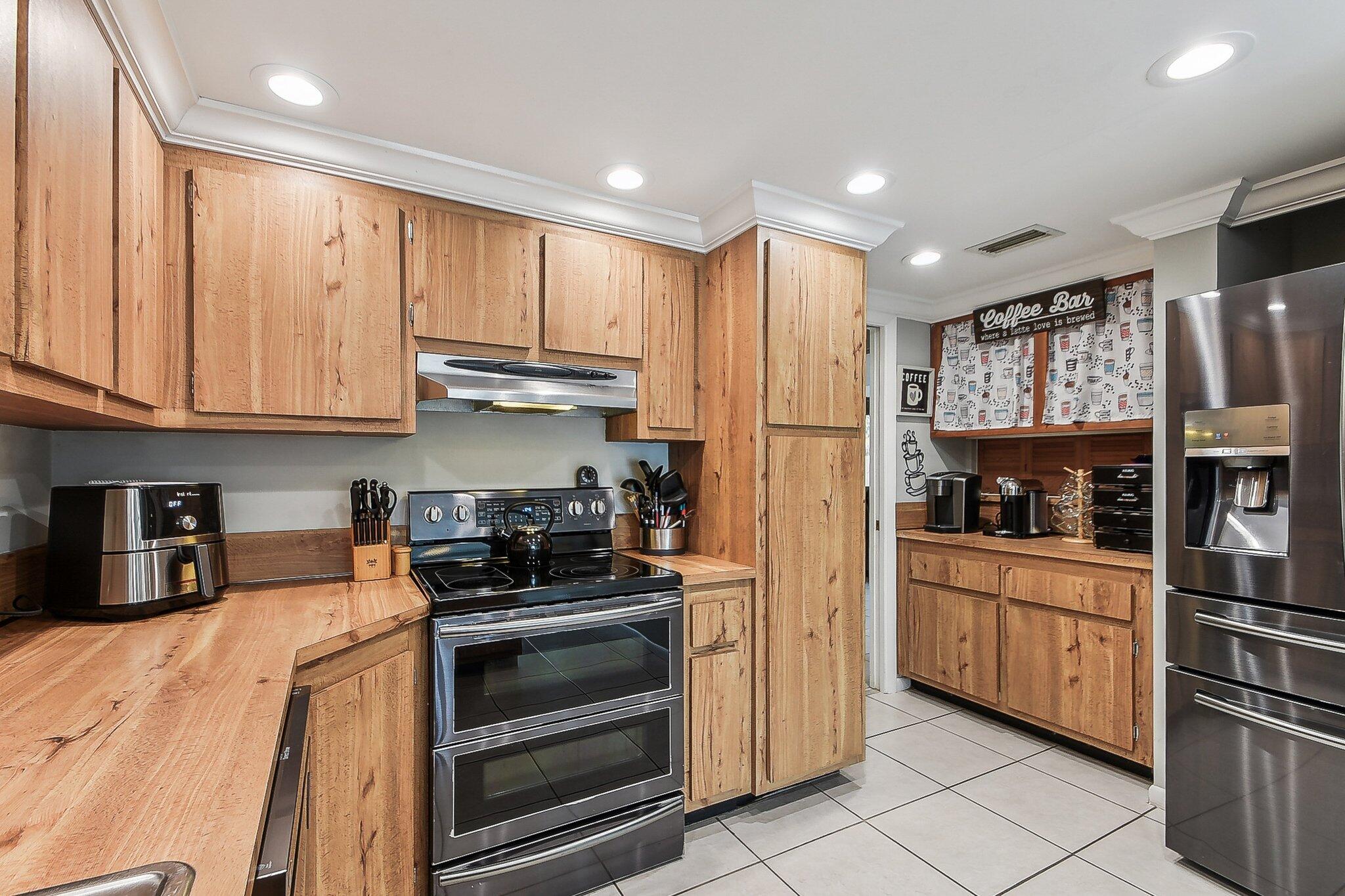 11063 Oakdale Road Boynton Beach, FL 33437 - Photo 19 of 65 a kitchen with stainless steel appliances granite countertop a refrigerator and a stove top oven