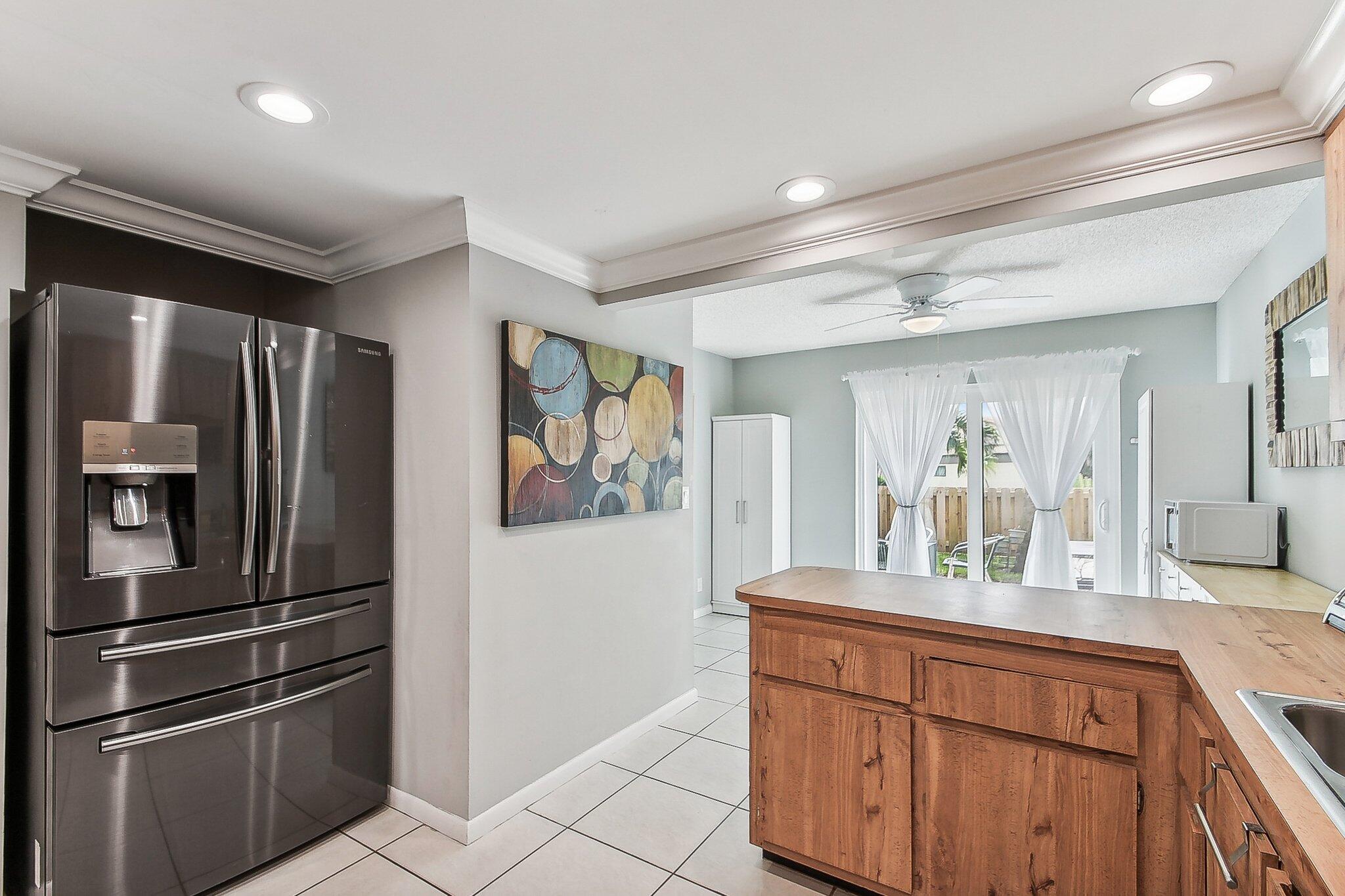 11063 Oakdale Road Boynton Beach, FL 33437 - Photo 20 of 65 a kitchen with stainless steel appliances granite countertop a refrigerator and a sink