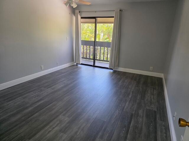 11063 Oakdale Road Boynton Beach, FL 33437 - Photo 27 of 65 a view of an empty room with wooden floor and a window