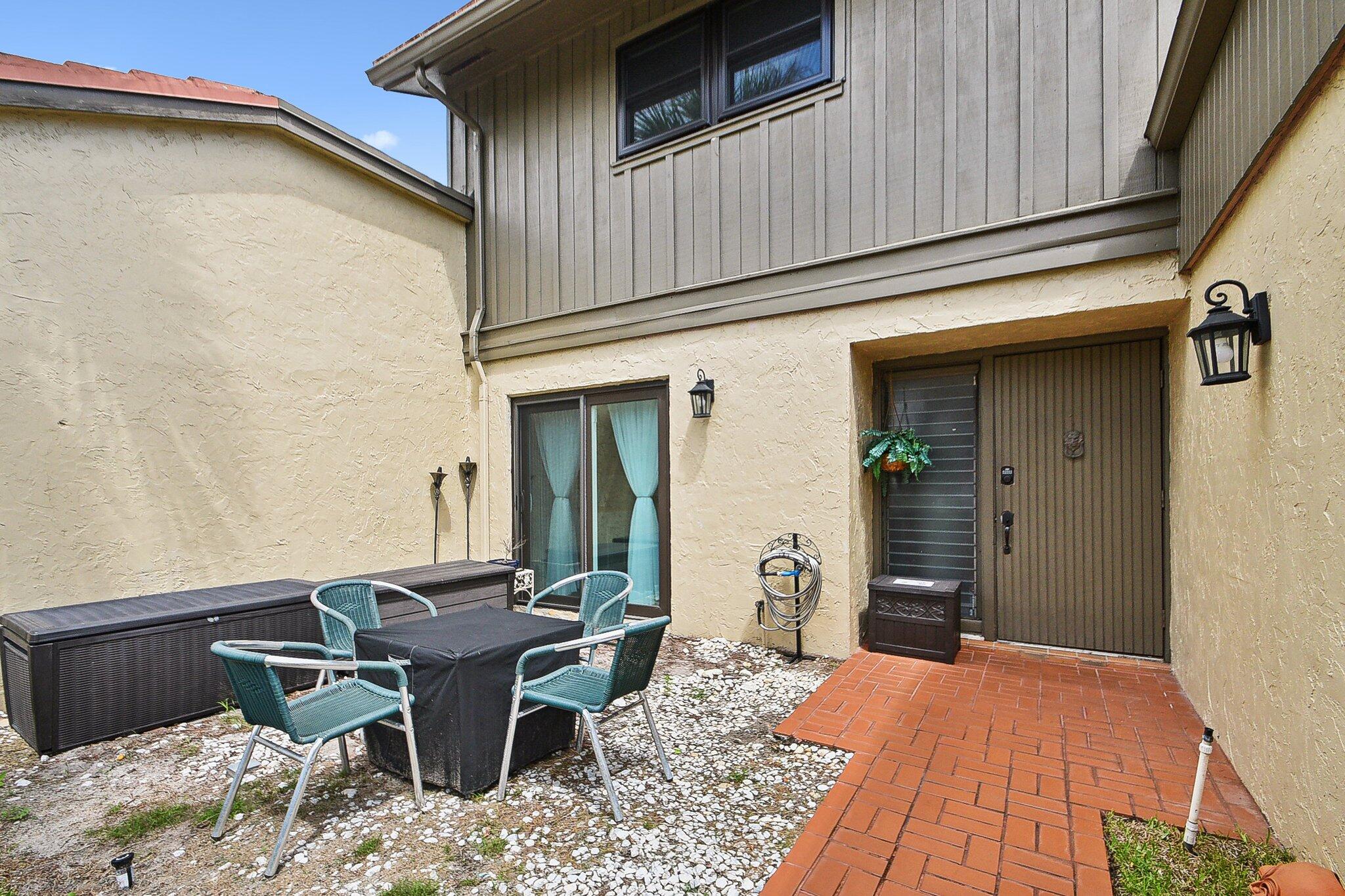 11063 Oakdale Road Boynton Beach, FL 33437 - Photo 3 of 65 a backyard of a house with table and chairs
