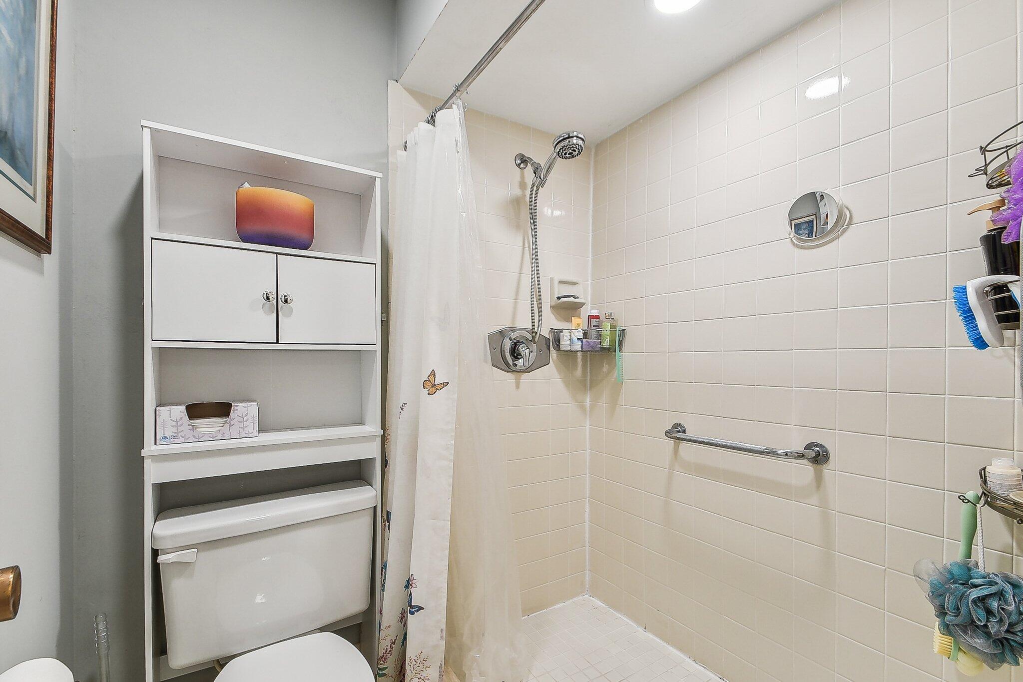 11063 Oakdale Road Boynton Beach, FL 33437 - Photo 33 of 65 a bathroom with a sink a toilet and shower