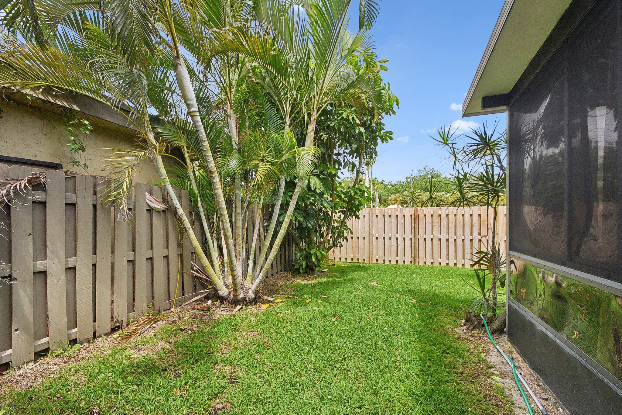 11063 Oakdale Road Boynton Beach, FL 33437 - Photo 45 of 65 a view of a house with a small yard and wooden fence