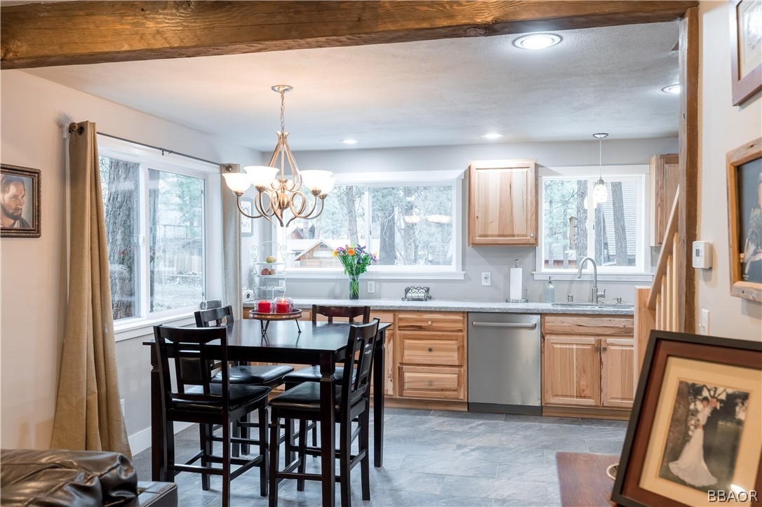 270 Spruce Lane Sugarloaf, CA 92386 - Photo 14 of 39 a kitchen with a dining table chairs and white cabinets