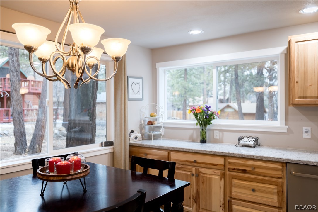270 Spruce Lane Sugarloaf, CA 92386 - Photo 15 of 39 a kitchen with a table and a chandelier